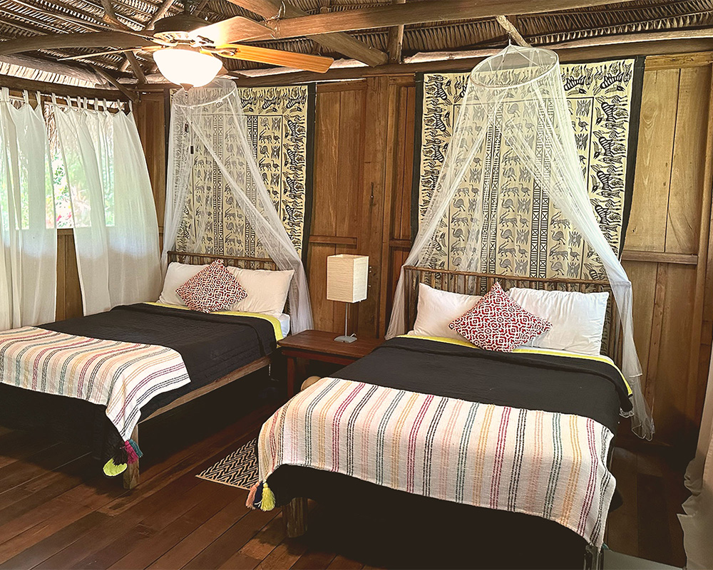 Two beds in a thatched casita.