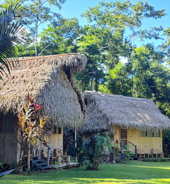 A manicured garden with the fronts of 2 casitas in view.